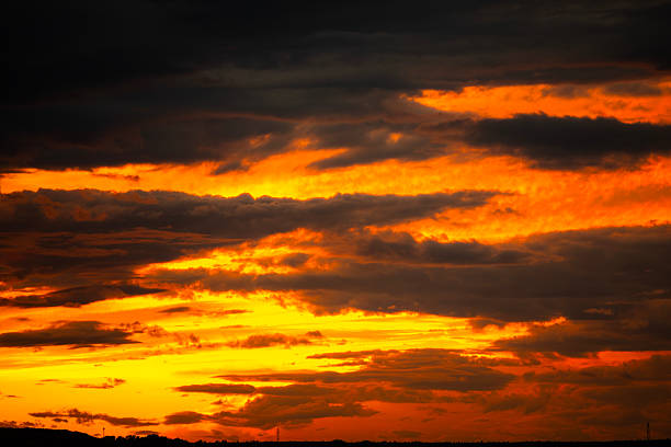Dramatic sunset over lake. Dramatic sky with dark clouds.