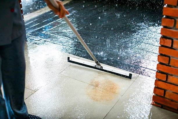 istock Selective focus to worker using wiper or squeegee to clean floor surface. Staff cleaning floor with wiper. The concept of cleaning service. 2241752334