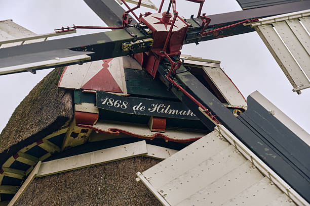 Visvliet, Netherlands ; October 11, 2025: Detailed view of Hilmahuistermolen windmill head with sails and shutter reefing system, showing nameplate and windshaft, symbol of Dutch mechanical heritage.
