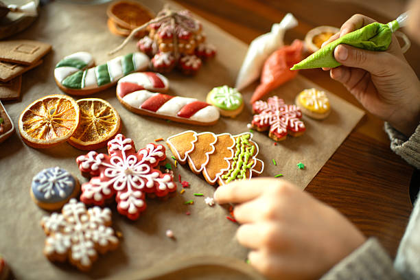 istock Boy decorating Christmas gingerbread cookies 2241757454