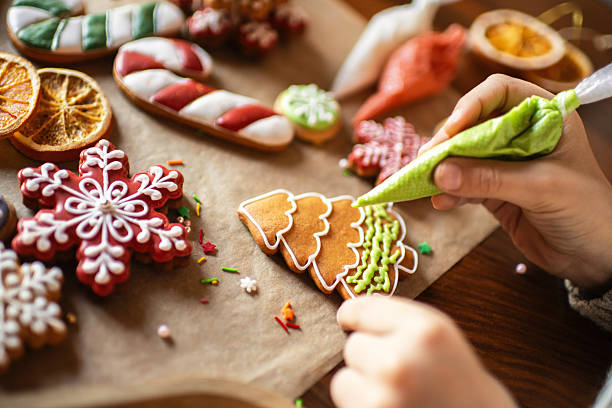 istock Boy decorating Christmas gingerbread cookies 2241757457
