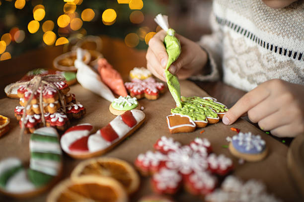 istock Boy decorating Christmas gingerbread cookies 2241757485