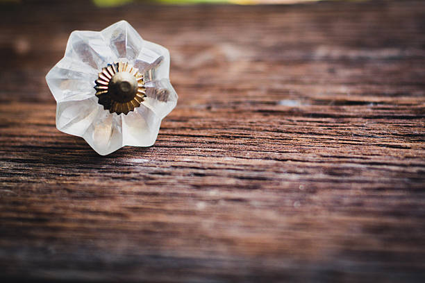 istock Vintage glass star drawer knob on rustic wood surface. 2241760118