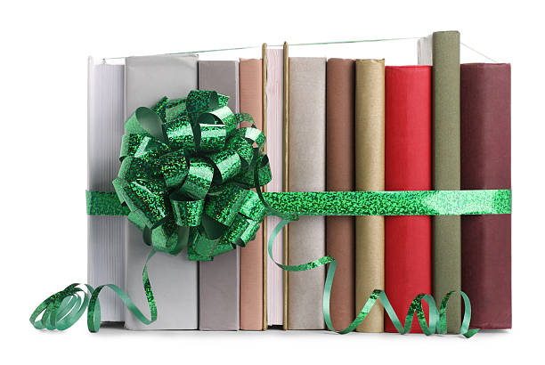 Many books with green bow as gift isolated on white