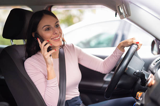 istock Woman driving a car while talking on the phone 2241762069