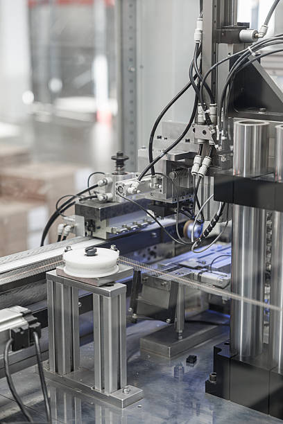 istock Close-up of an industrial wire processing machine featuring rollers, pneumatic actuators, and numerous cables in a high-tech automation system. Includes copy space 2241762963