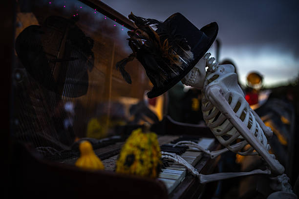 Halloween. Spooky Halloween skeleton with skull and bones in dark background, creepy horror decoration glowing in eerie light for Halloween night.