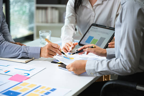 istock Business documents on office table with smart phone and calculator digital tablet and graph business with social network diagram 2241763249