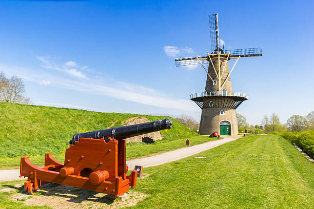 istock Historic cannon in front of an old windmill in Gorinchem 2241765682