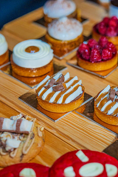 istock “Assorted artisanal desserts and pastries displayed on wooden table in modern bakery” 2241765717