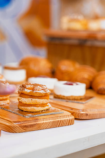 istock “Assorted artisanal desserts and pastries displayed on wooden table in modern bakery” 2241765752