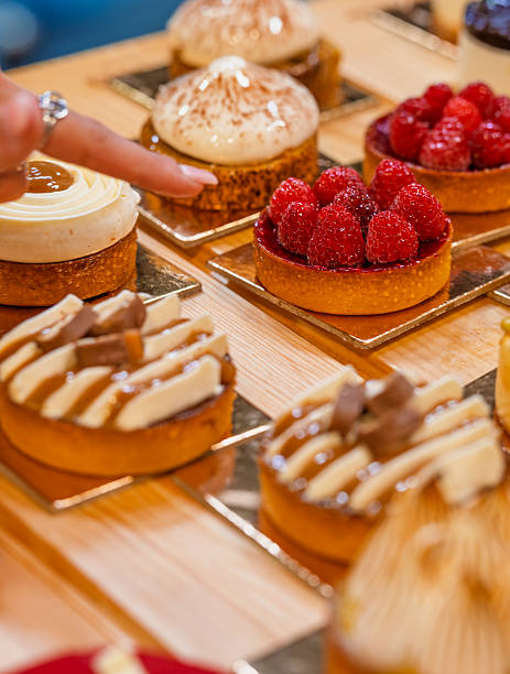 istock “Assorted artisanal desserts and pastries displayed on wooden table in modern bakery” 2241765775