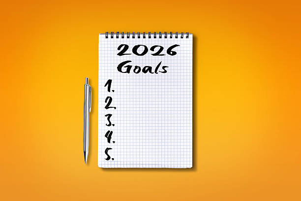 istock 2026 Goals lettering on checkered notebook, isolated on orange b 2241765949