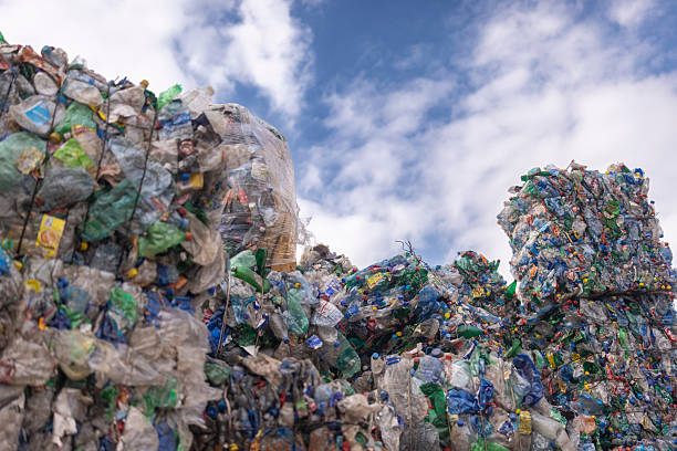 istock Large Stacks Of Compressed Plastic Bottles Piled Outdoors Under Blue Sky 2241768798