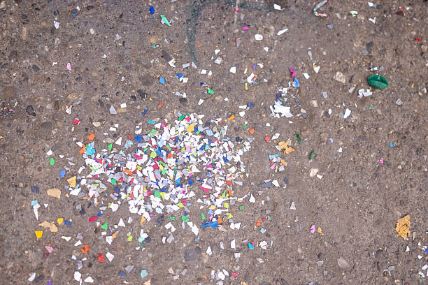 istock Close Up View Of Small Pieces Of Multicolored Plastic Debris On Ground Surface 2241768804