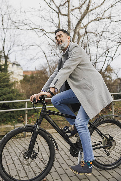istock Man Riding Bike Down Brick Walkway  In the Park 2241769666