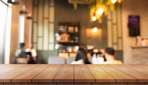 istock Empty wooden table top with lights bokeh on blur restaurant background. 2241769879