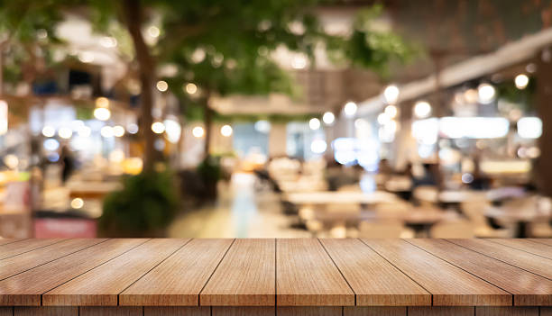 istock Empty wooden table top with lights bokeh on blur restaurant background. 2241769882