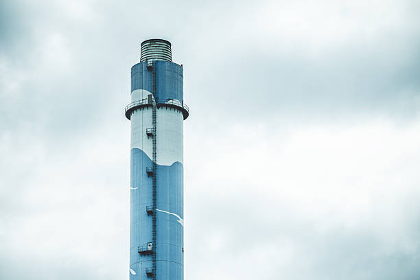 large industry chimney, hot gas pipe releases against cloudy sky background
