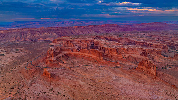 istock Red rock formations at dusk in Arches. Drone view of dramatic red rock formations in Arches National Park at dusk under colorful clouds. 2241770872