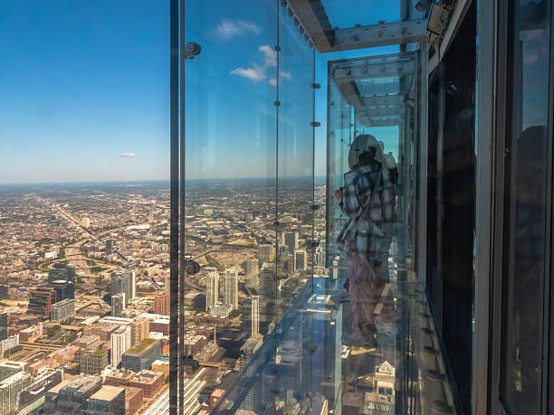 A hand holds a magnifying glass, framing a unique view of a vibrant cityscape, illustrating the relationship between urban life and the beauty of observation and exploration.