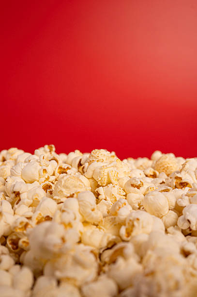 istock Pile of Popcorn Against Red Background 2241776585