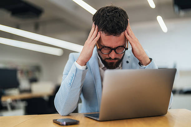 istock Overworked Businessman with headache 2241777502