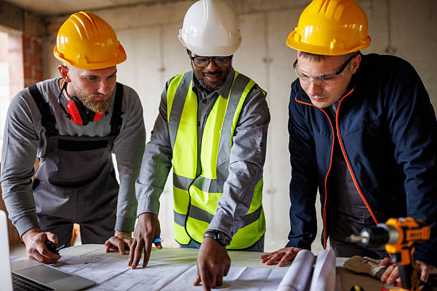 istock Team of engineers and builders discusses a construction plan inside an unfinished building 2241780394