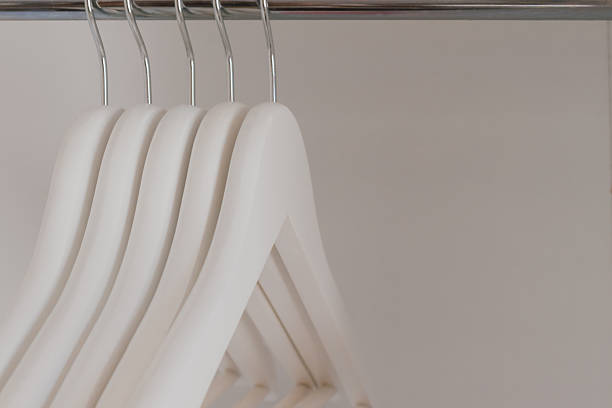 istock Quality massive wooden white hangers in the wardrobe. 2241782638