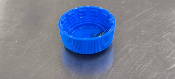 istock Blue soda bottle caps on a stainless steel table 2241787629