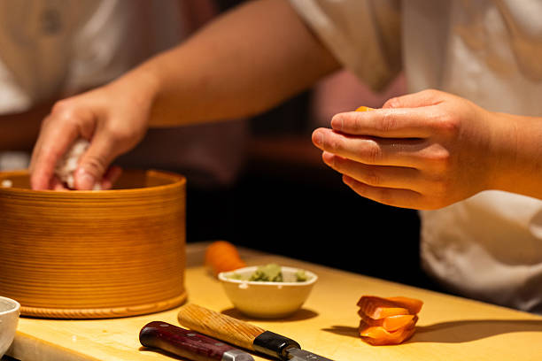 istock Skilled chef preparing sushi rolls with fresh ingredients in kitchen 2241792068