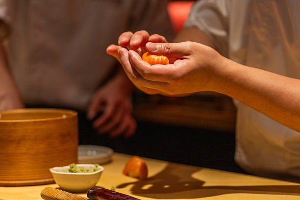 istock Skilled chef preparing sushi with fresh ingredients in a vibrant kitchen 2241792096