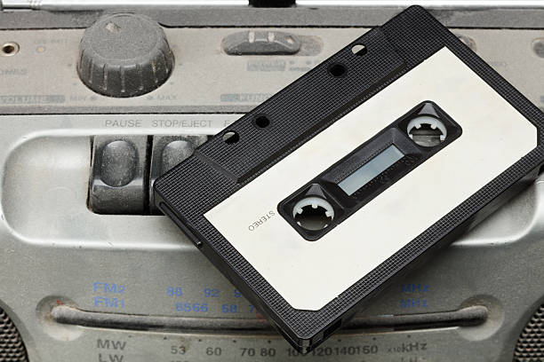 istock Audio cassette on a dusty tape recorder 2241792138
