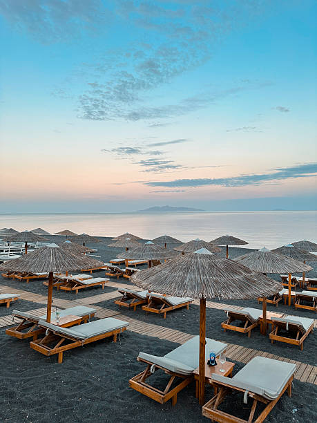 istock Sunset over Kamari Beach Loungers and Umbrellas 2241796676