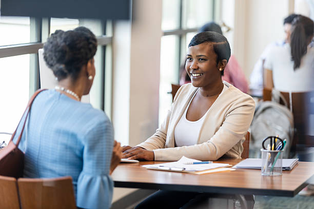 istock Two women in a professional setting engage in a friendly conversation. 2241796977
