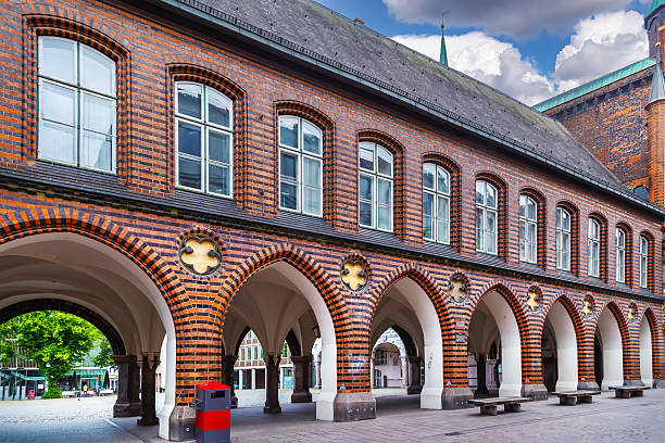 Paris, France: Pedestrians/shoppers walk under the arches on Place des Vosges in the 3rd arrondissement.