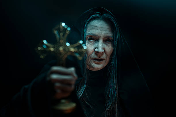 istock Dark Horror Nun Holding Cross in Exorcism Scene 2241797924