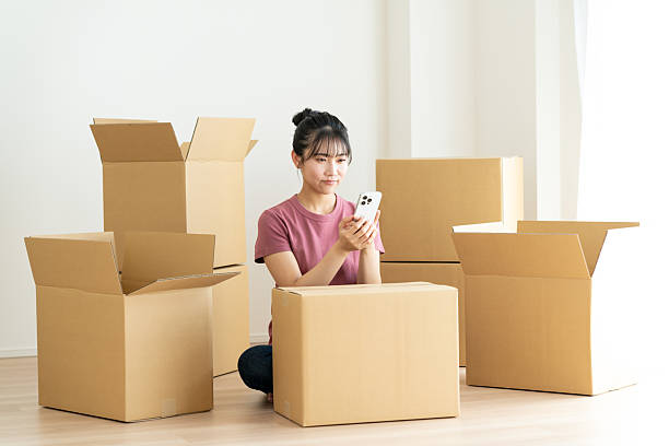 istock Young woman moving house 2241798064