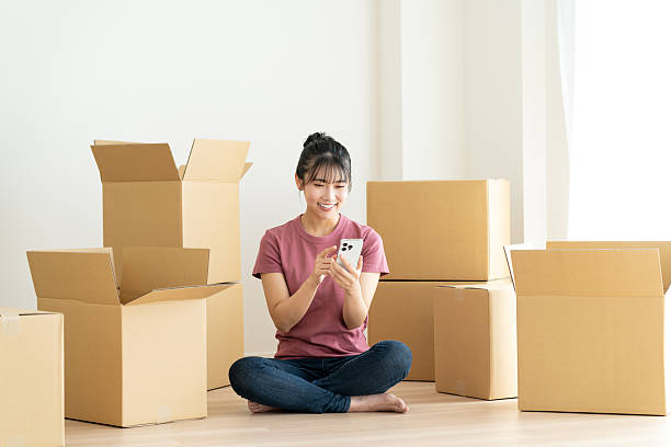istock Young woman moving house 2241798123