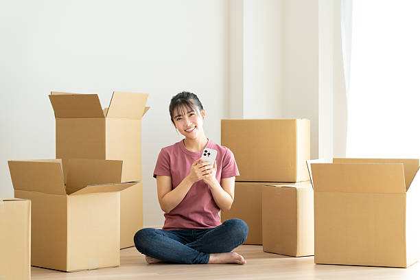istock Young woman moving house 2241798128