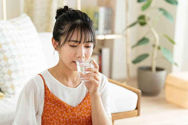 istock Young woman drinking water 2241798637