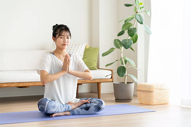 istock Young woman doing yoga at home 2241798841