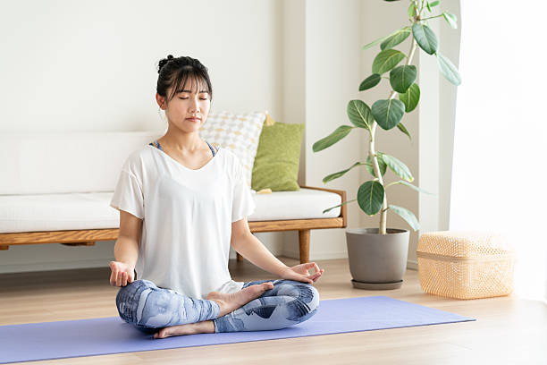 istock Young woman doing yoga at home 2241799345