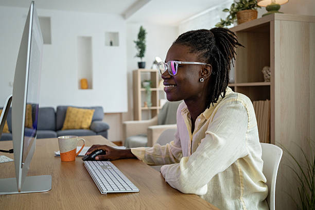 istock A young black woman with eyeglasses working on her computer from her home office 2241801457