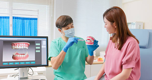 istock dentist shows correct way to brush teeth 2241802091