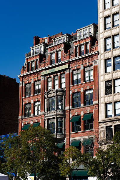 istock A large brick building with a green awning and a clock on the side 2241802718