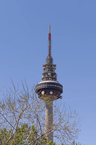 istock Telecommunications tower of Madrid along with some tree branches a bit of blue sky 2241803092