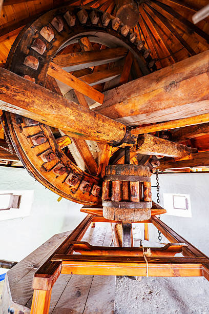istock Rudimentary wood and stone machinery grinding from an ancient windmill 2241803741