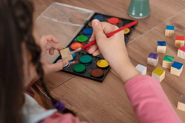 istock Girl painting cubes 2241803771