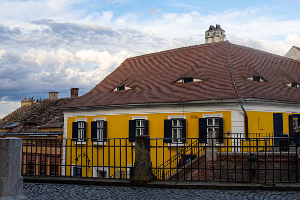 Sibiu, Romania. December, 16, 2022. Traditional old house in Sibiu with eye shaped attic windows
